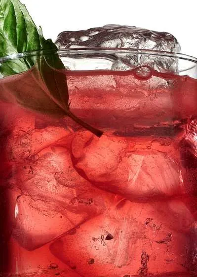 Drink rosso con ghiaccio e basilico